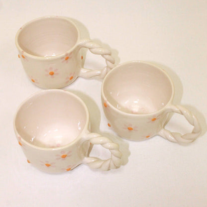 Taza con margaritas y asa trenzada